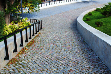 neat cozy paved path in the city park