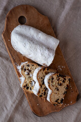 Homemade Christmas Stollen Bread on a rustic wooden board, top view. Flat lay, overhead, from above.