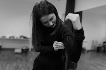 A girl learns to apply a tourniquet to prevent bleeding during indoor first aid training