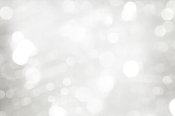 Elegant Abstract Silver Christmas Background with white bokeh lights for Holiday Poster, Banner, Ad, Card or invitation.