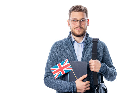 Handsome caucasian male in eyeglasses holding Britis flag and looking to camera