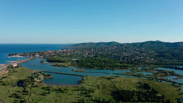 Villepey pond and Saint aygulf city aerial shot France sunny day