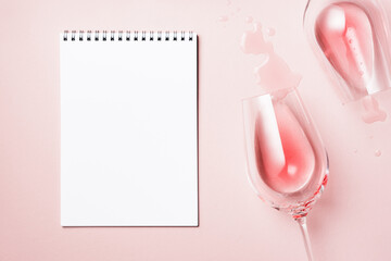 Two glasses of rose wine and  sheet of paper.