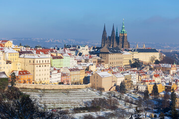 Snowy Prague City with gothic Castle from Hill Petrin in the sunny Day, Czech republic