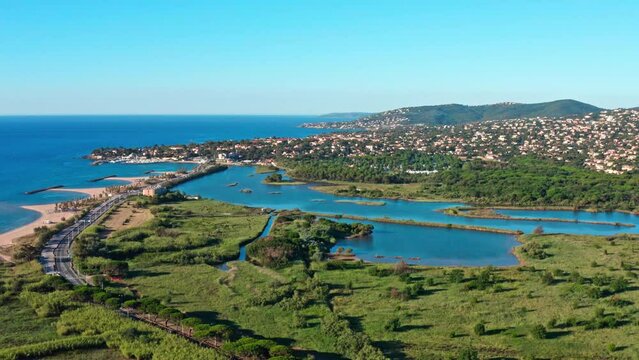 Aerial shot of Saint Aygulf villepey ponds in front of the mediterranean sea 