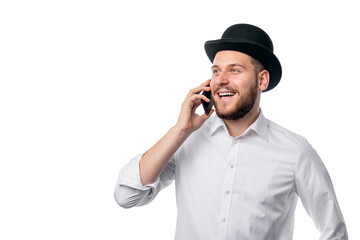 Portrat of stylish hipster male in old-fashioned hat talking on phone isolated on white background.