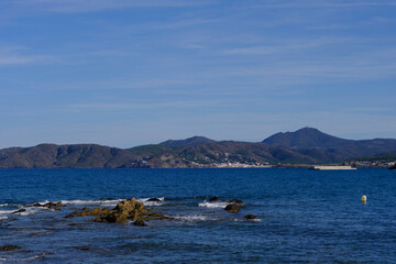 Fototapeta na wymiar Coastal landscape with some rocks on the edge of a blue Mediterranean Sea in Costa Brava