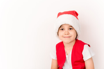 Portrait of smiling beautiful child in red Santa Claus hat isolated on white background. 5 year happy little European boy. Banner. Copy space. Christmas time mockup design. New Year holiday. Fun kid