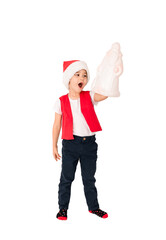 WOW. Portrait of standing child in red Santa Claus hat holding gift toy. Cute 5 year European happy boy. Isolated on white background. Vertical. Copy space. Christmas and New Year holidays concept