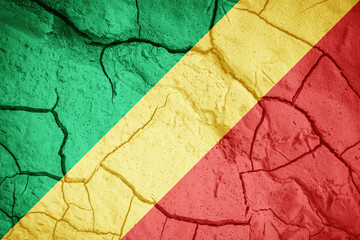 Flag of Congo. Congo symbol. Flag on the background of dry cracked earth. Congo flag with drought concept