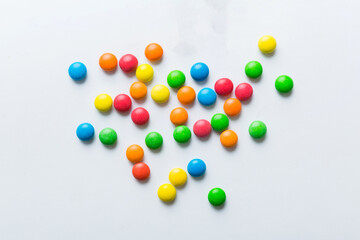 Mixed collection of colorful candy, on colored background. Flat lay, top view. frame of colorful chocolate coated candy