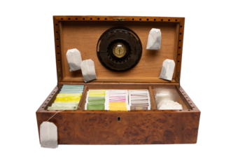 wooden box with humidor filled with tea of different flavors and colors and oak root tea bag wooden cigar box with pure white background with space for text