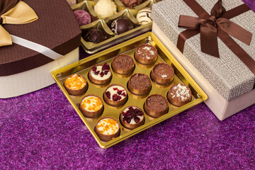 Box with delicious chocolate candies and heart shape gift