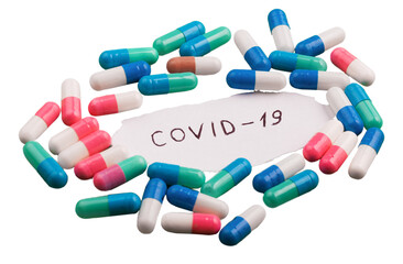 Coronavirus disease named covid 19 handwriting on paper with pill
