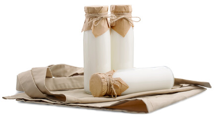 Fresh organic milk in glass and jug on rustic tablecloth