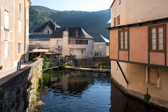 Architecture of houses in front of a river in the village of Florac in the Cevennes, France
