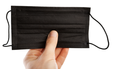 A medic's hand holding face mask over blue textured. Protective respiratory mask