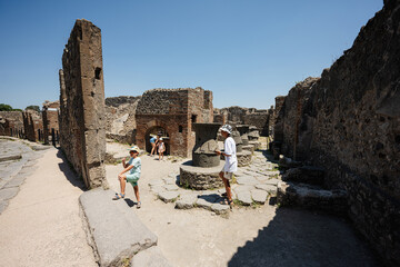 Children tourist walking at Pompeii ancient city, Italy.