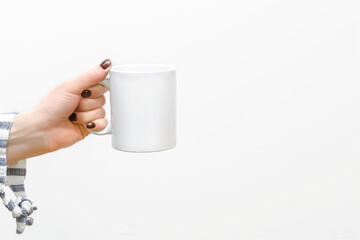 Woman's female hands holding white cup mug of coffee on white background.mockup,template for design