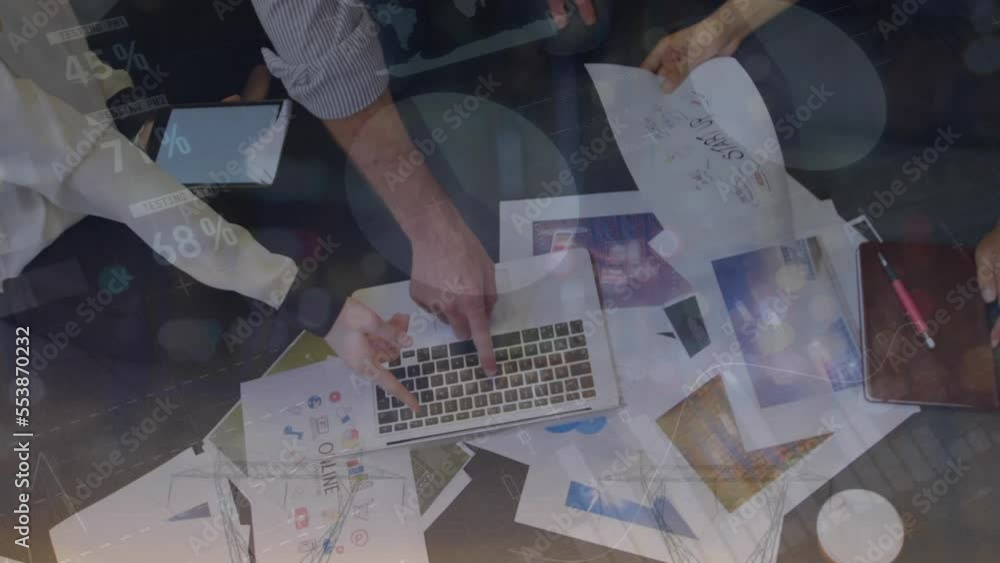 Poster animation of statistical data processing over mid section of colleagues discussing over a laptop