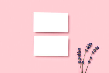 Mockup two cutaway, discount, business card on a pink minimalism background and lavender flowers with copy space. Template for design