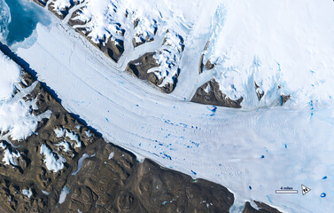 Aerial view of meltwater lakes forming on the surface of Greenland’s Petermann Glacier. Digitally enhanced. Elements of this image furnished by NASA.   © Bluee