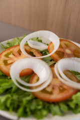 Fresh salad with lettuce, tomato and onion. Typical Brazilian food. Selective focus