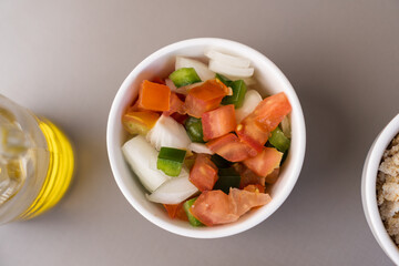Delicious vinaigrette with tomato, onion, bell pepper. Top view. Typical Brazilian food. Selective focus