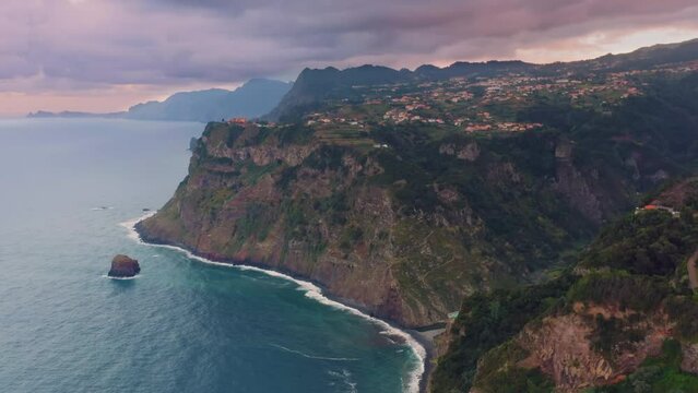 Aerial view of Madeira island green hills and coastline at sunset