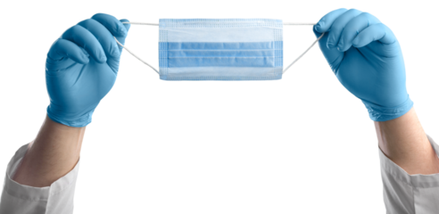 A medic's hand holding face mask over blue textured. Protective respiratory mask