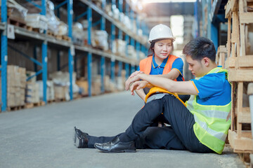 Tired  warehouse worker staff sitting on floor in warehouse. This is a freight transportation and distribution warehouse. Industrial and industrial workers concept