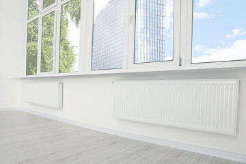 Fototapeta na wymiar Modern office room with radiators and windows. Interior design