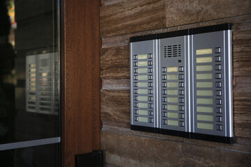 Modern intercom system on stone wall, space for text. House security