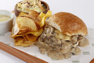 Philly cheesesteak closeup, with chips and side salad