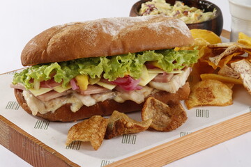 Cuban bread sandwich with ham, bacon, cheese, lettuce, tomato and onions