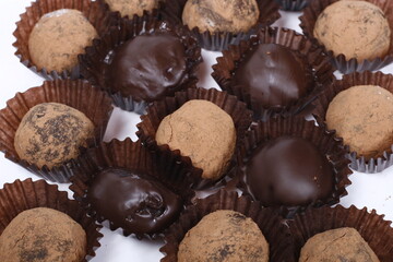 Closeup of chocolate truffles, some chocolate coated, some dusted with cocoa powder