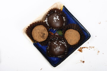 Closeup of chocolate truffles, some chocolate coated, some dusted with cocoa powder