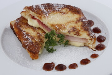 Gourmet grilled ham and cheese sandwich with powdered sugar