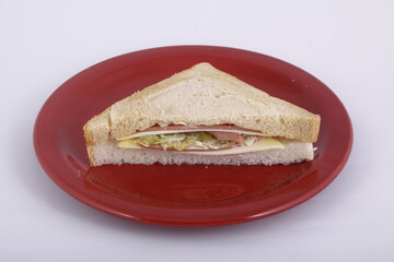 Ham and cheese sandwich on a red plate