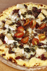 Gorgonzola pizza with whole cheese slices, cherry tomatoes, ground beef