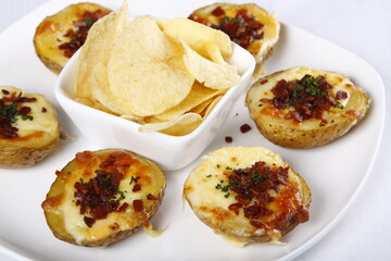 Loaded baked potato with bacon and cheese, with chips