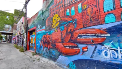  Colourful graffiti paintings on graffiti alley in Toronto, Canada.  Street art, background, texture. © Elton