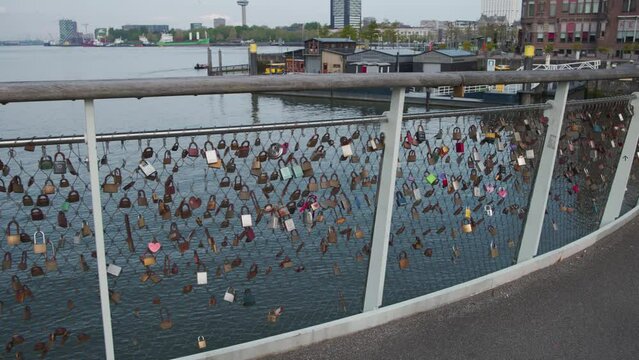 Padlocks on fence of love lock bridge in Rijnhaven harbor in Rotterdam.
