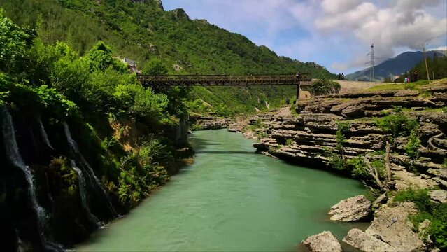 Drone shot over turquoise water stream river in Tepelena city, Albania