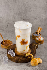Boba or tapioca pearls is taiwan bubble milk tea in plastic cup with pineapple jam flavor on texture  background, summers refreshment.