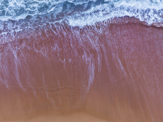 Top view of Beach sea surface, Shot in the open sea from above,Amazing nature background of blue sea Water surface waves reflecting the Sunlight