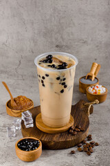 Boba or tapioca pearls is taiwan bubble milk tea in plastic cup with milk tea flavor on texture  background, summers refreshment.