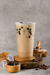 Boba or tapioca pearls is taiwan bubble milk tea in plastic cup with milk tea flavor on texture  background, summers refreshment.