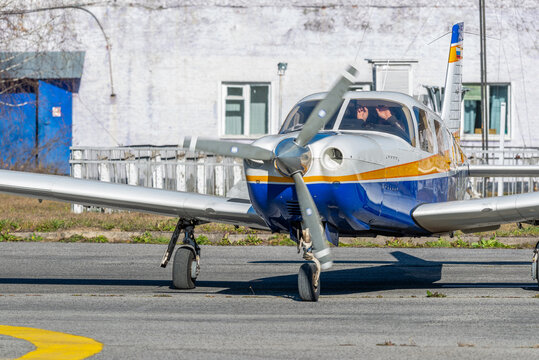 One-engine propeller aircraft parked at a small airport