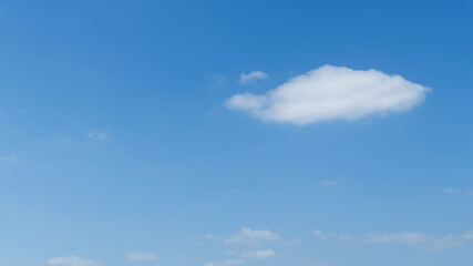 Single white cloud in blue sky